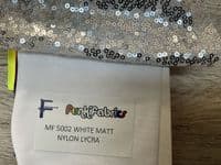 High front leotard with keyhole back and sequin skirt on silver waistband