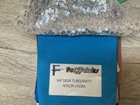 High front leotard with keyhole back and sequin skirt on silver waistband