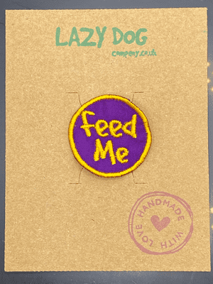 Embroidered Iron on Purple Feed Me Badge for Dogs by Lazy Dog Company.