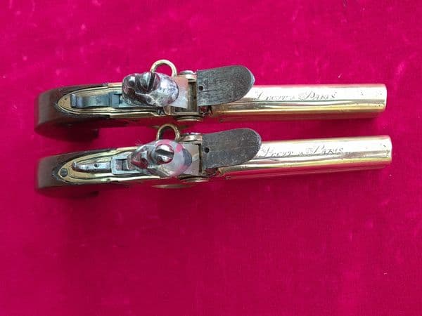 Pair of French over & Under double barrel brass tap action flintlock pistols. Circa 1780. Ref 3484