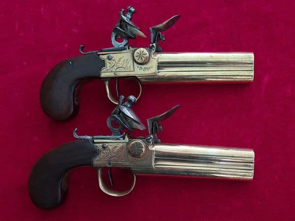 X X X SOLD X X XPair of French ove/ Under double barrel brass tap action flintlock pistols. Ref 3484