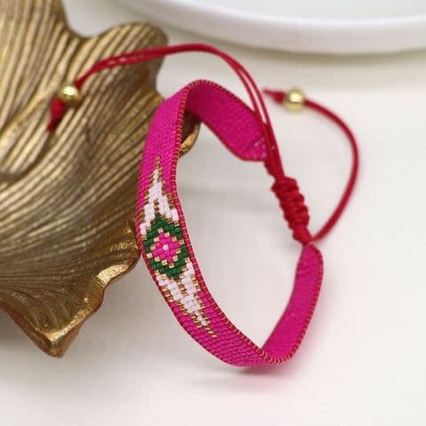 BRIGHT PINK 'EVIL EYE' HANDLOOMED BEADED RIBBON BRACELET