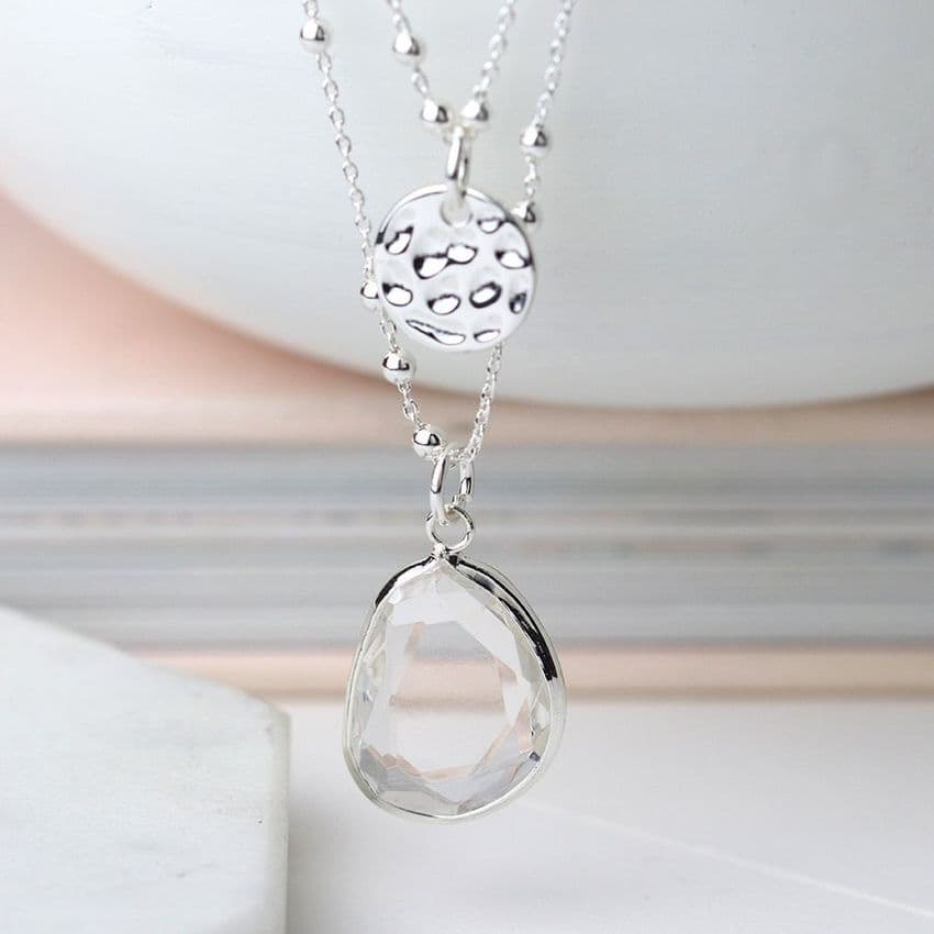 SILVER DOUBLE CHAIN NECKLACE WITH HAMMERED DISC AND LARGE GREY CRYSTAL DROP