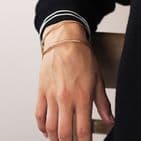SILVER PLATED AND FAUX GOLD IRREGULAR FOUR BANGLE SET WITH WORN FINISH