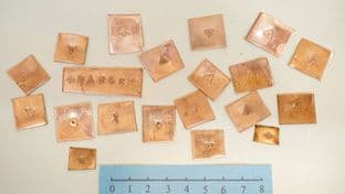 a one off set of copper pieces punched with metalworking stamps
