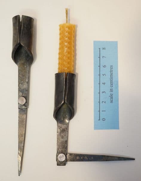 medieval folding candle holder in forged steel and beeswax candle