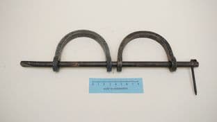 medieval hand shackles on a cross bar