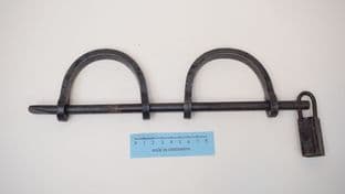 medieval slave or prisoner hand shackles on a cross bar