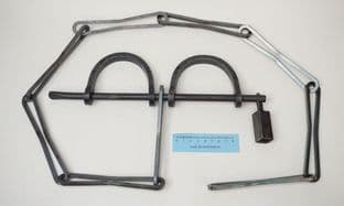 medieval slave or prisoner hand shackles on a cross bar with chain
