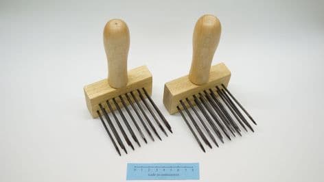 reenactment weaving pair of hand forged black steel wool combs