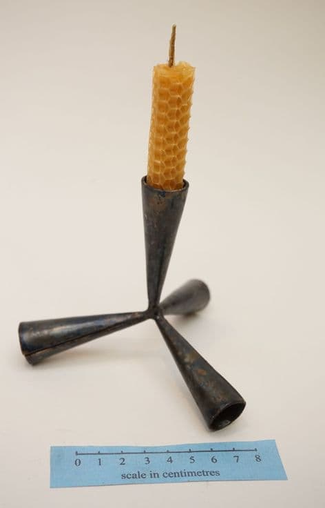 Roman caltrop candle holder from caerwent (UK) and beeswax candle