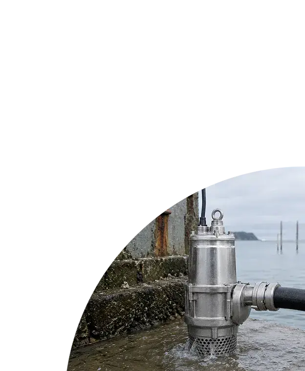Industrial stainless steel submersible seawater pump operating on a marine dock with discharge hose attached.