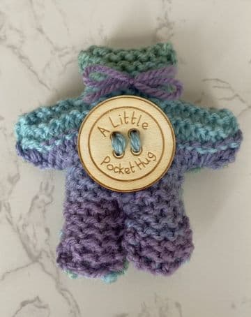 Pocket hug knitted teddy bear