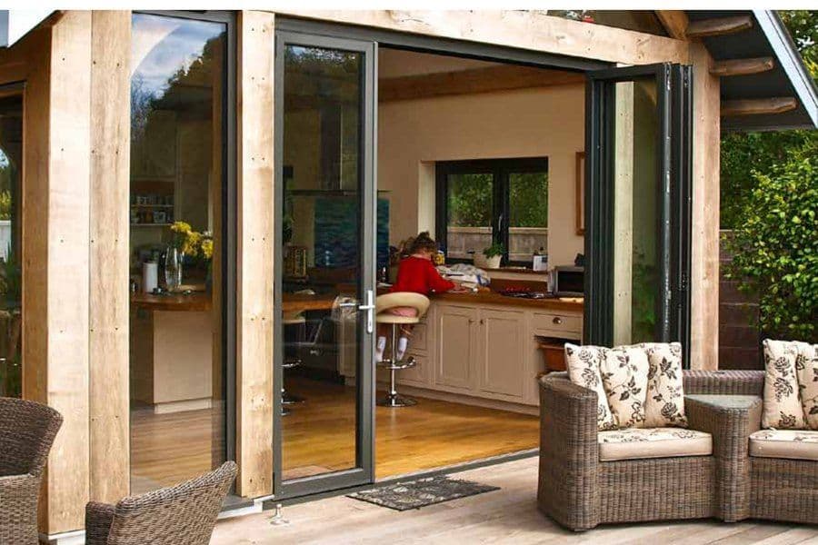 Aluminium bifold doors linking a home with the garden