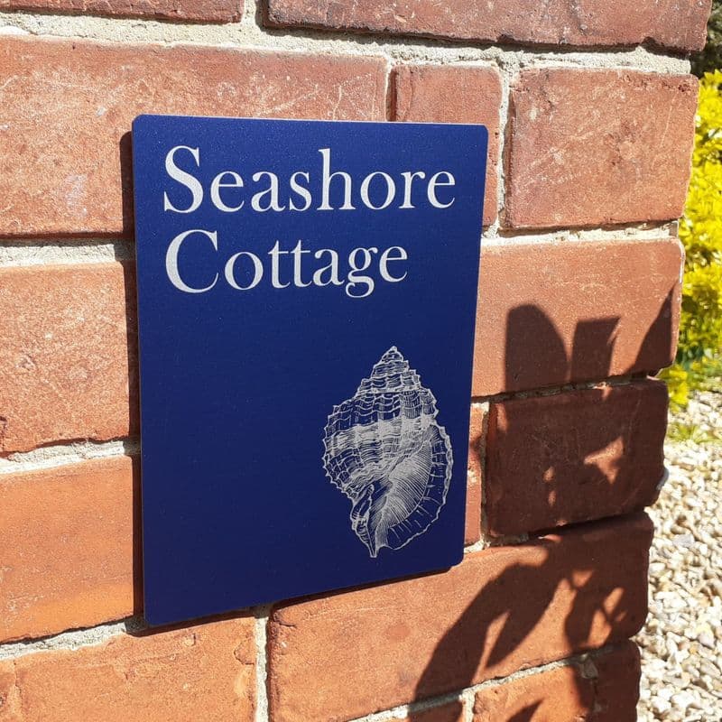 Conch shell on navy house sign