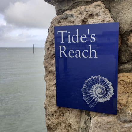 Triton shell house sign on navy