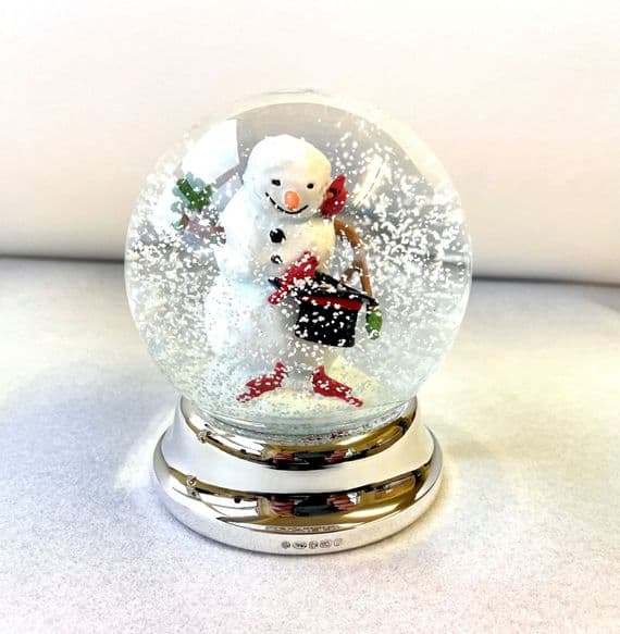 Snowman Snow Globe with silver foot.