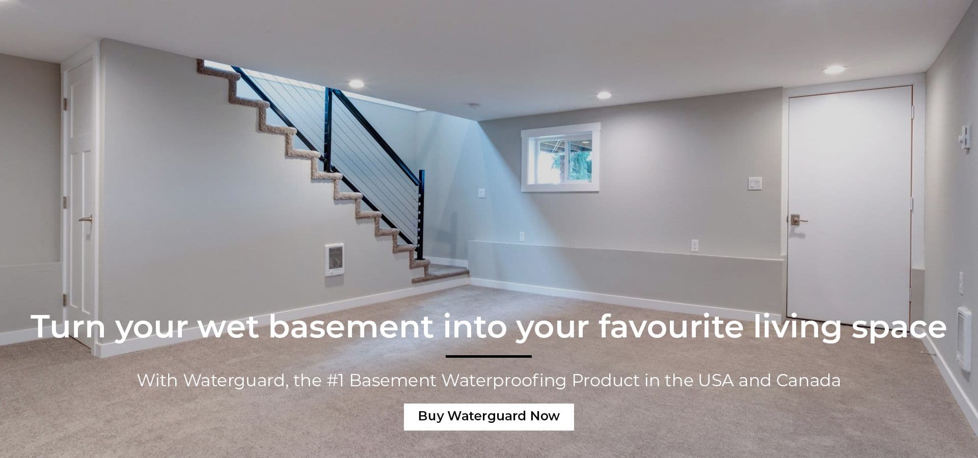 Corner of a dry finished and habitable basement showing finished walls and staircase coming down into the basemetn after the installation of Waterguard Perimeter basement drainage channel