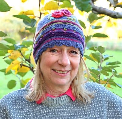 Beanie knitted hat in purple with flower embroidery