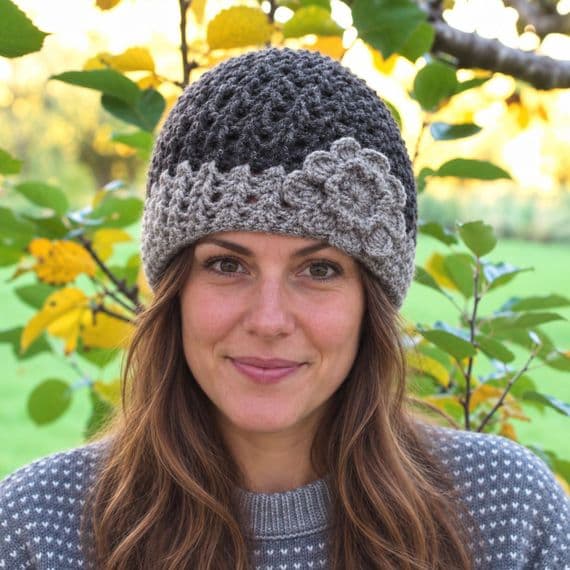 Dark grey beanie with light grey border and flower