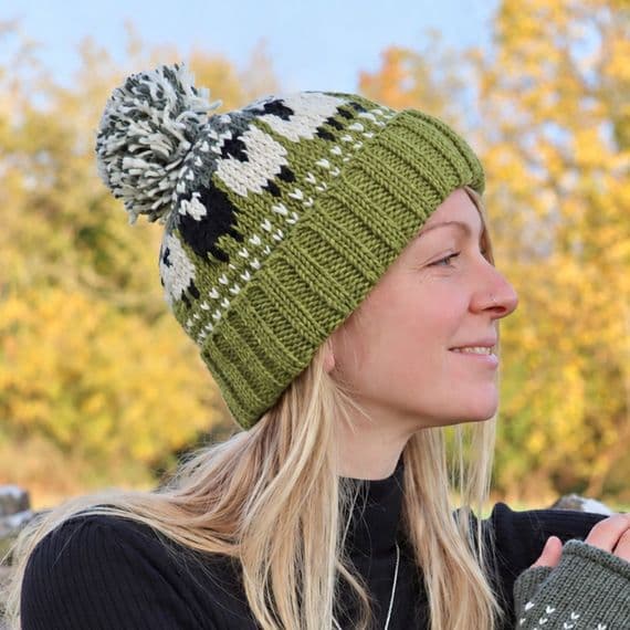 Green Knitted Bobble Hat With A Black Sheep And Fleece Lining