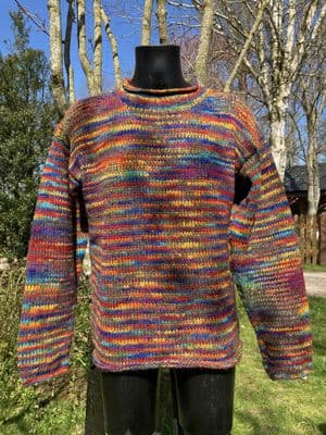 Hand knitted woollen jumper in soft grey and rainbow stripes