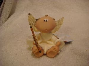 Angel Cheeks holding a flute