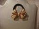 Hair band ponytail holder bow in cream and red.