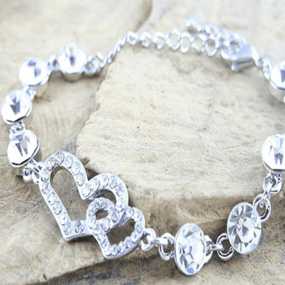 CZ Tennis Bracelet With Entwined Hearts in a Polished Finish