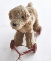 Small pull-along dog on wheels
