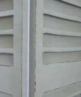 Tall louvred distressed French green shutters