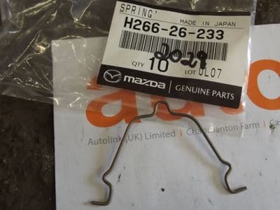 Brake pad spring clip, rear, Bongo all models, genuine Mazda, H26626233