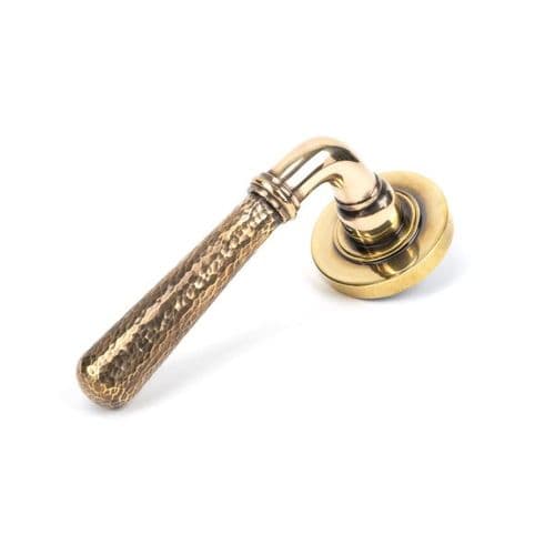 From the Anvil Hammered Newbury Door Handle on Plain Rose - Pair - Aged Brass - 46069