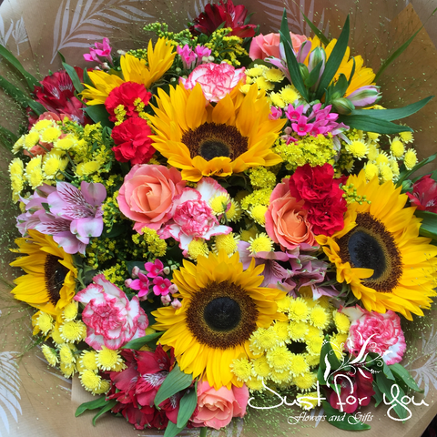 Exclusive Florist Choice Hand tied arrangement available in bright colours + glass vase