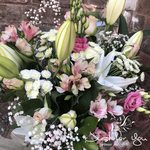 Exclusive Florist Choice Hand tied arrangement available in pastel colours + glass vase