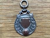 A Silver and Rose Gold Football Fob - Hallmarked Birmingham 1925
