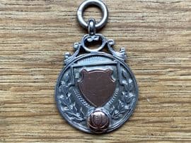 A Silver and Rose Gold Football Fob - Hallmarked Birmingham 1925