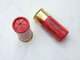 Inert 12 bore cartridge in waxed paper in red, deep brass cap