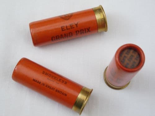 Inert 12 bore shotgun cartridge with waxed paper casing in orange,  Blanked end