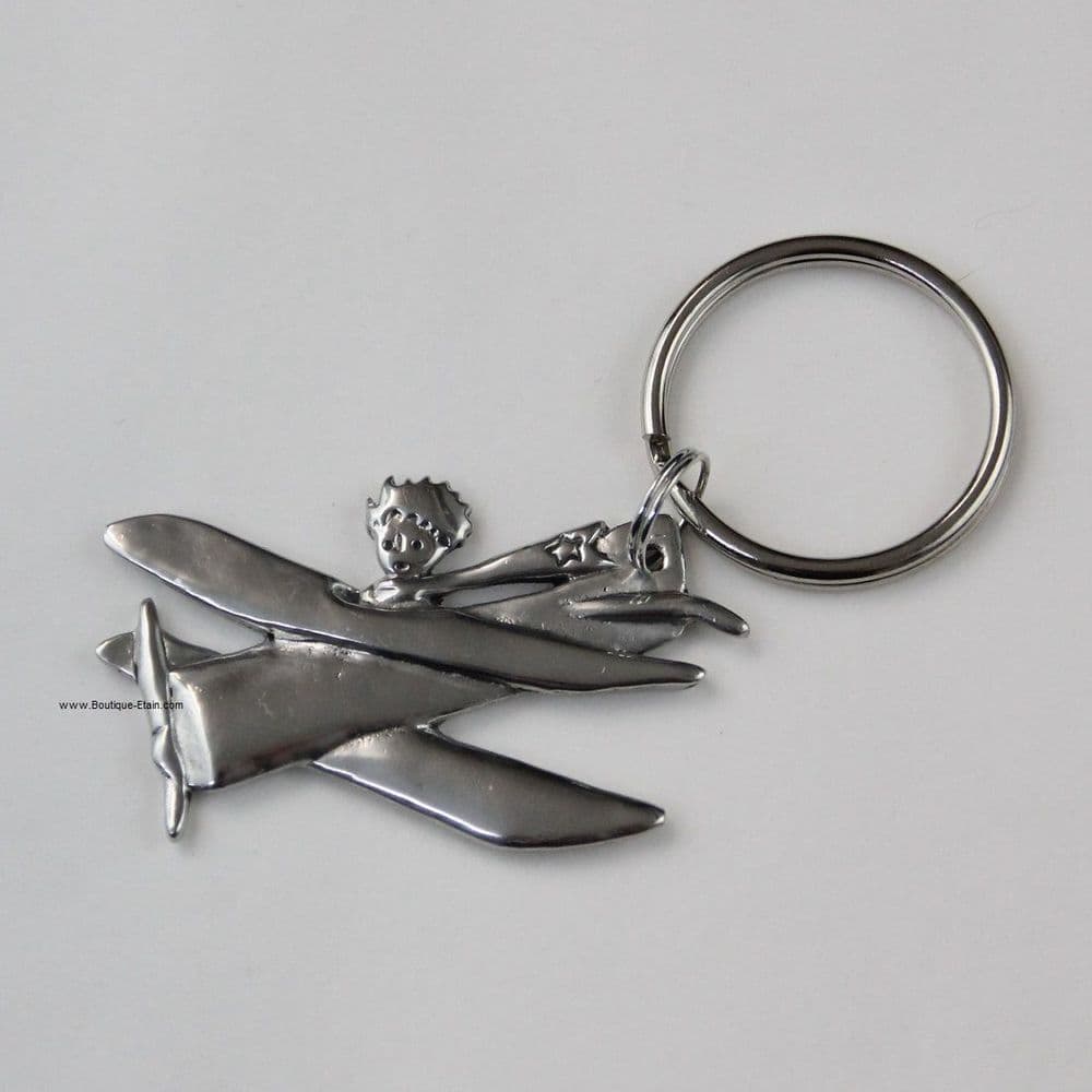 Porte-clés ou porte-clefs Le petit Prince dans son avion en étain.