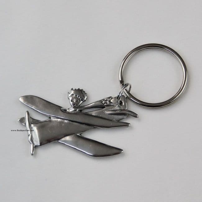 Porte-clés ou porte-clefs Le petit Prince dans son avion en étain.
