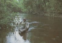 Child In Canoe Rowing Boat in Iquitos Peru Postcard