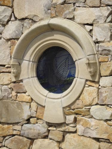 Gothic round hooded window.