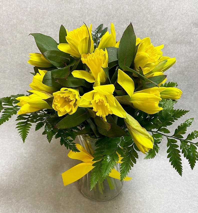 Daffodils in a glass vaseEssex flowersBlossom florists