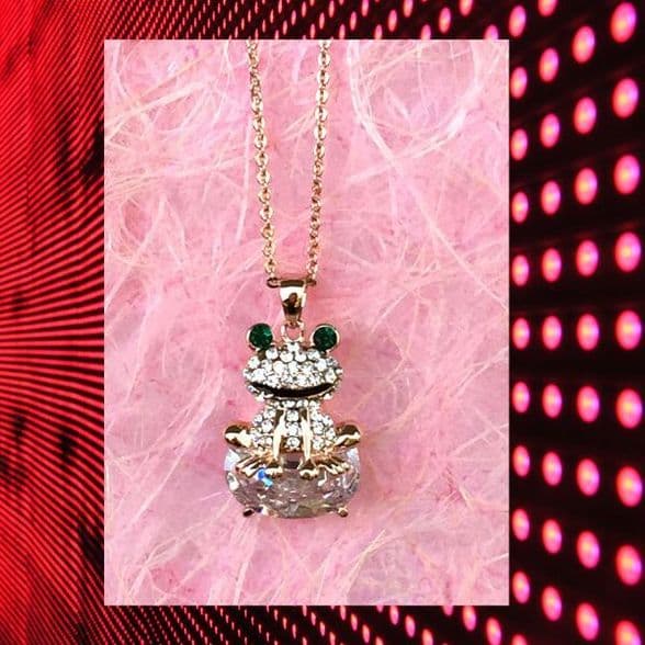 A beautiful butterfly pendant made of mother of pearl and emblazoned with small glittering crystals on a gold metal base. J020010