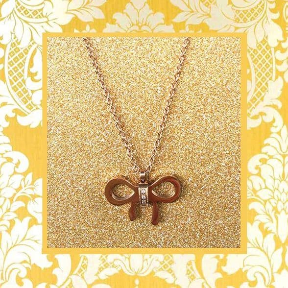 A beautiful butterfly pendant made of mother of pearl and emblazoned with small glittering crystals on a gold metal base. J020010