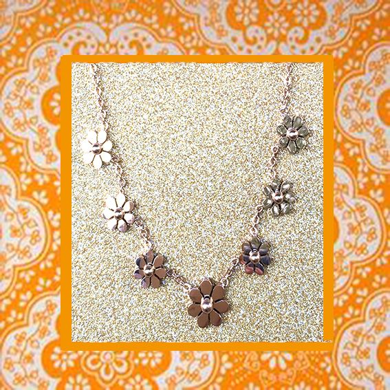 A beautiful butterfly pendant made of mother of pearl and emblazoned with small glittering crystals on a gold metal base. J020010