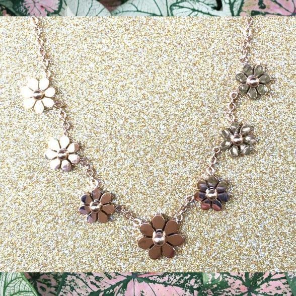 A beautiful butterfly pendant made of mother of pearl and emblazoned with small glittering crystals on a gold metal base. J020010