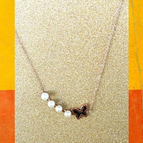 A beautiful butterfly pendant made of mother of pearl and emblazoned with small glittering crystals on a gold metal base. J020010