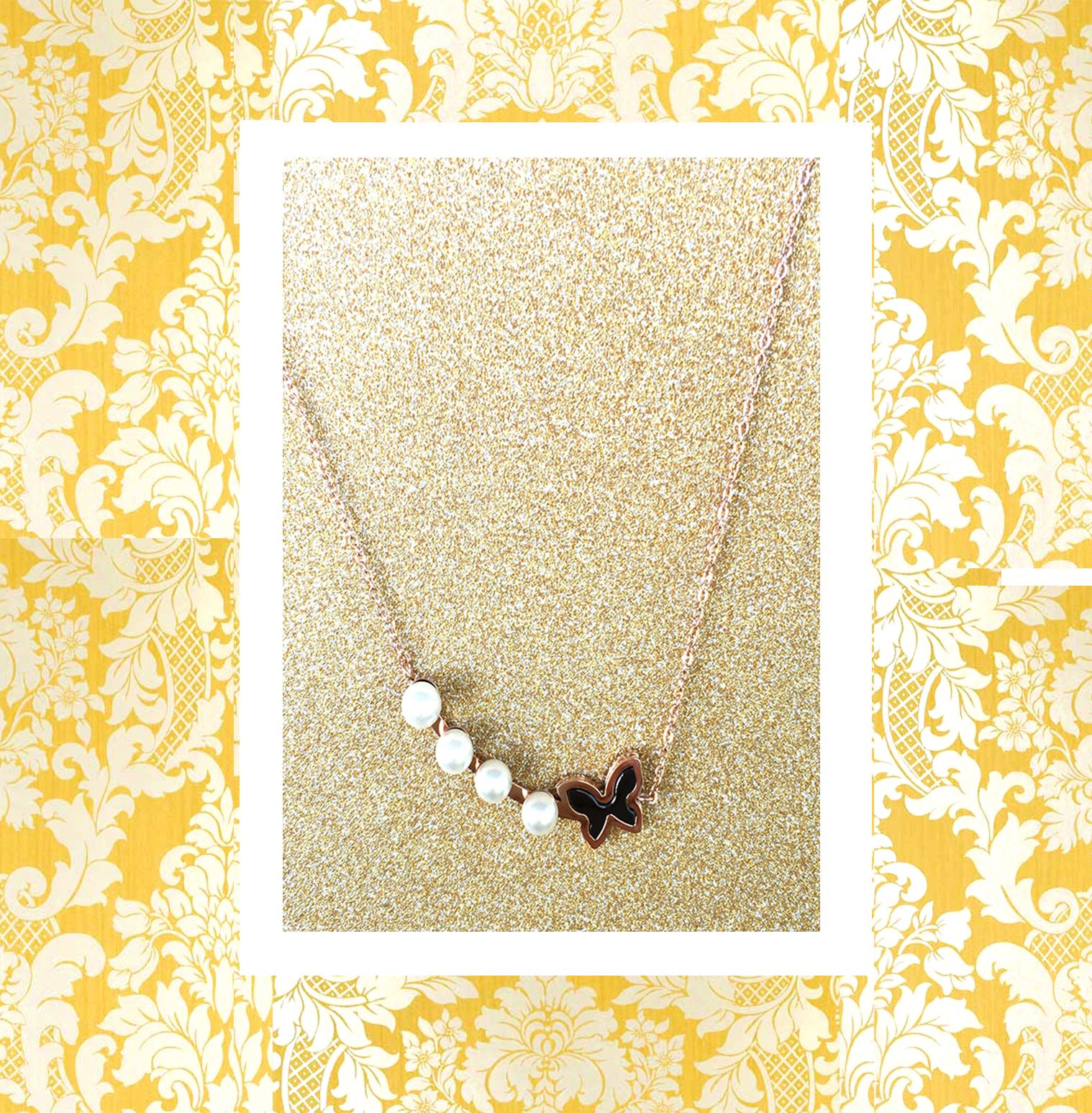 A beautiful butterfly pendant made of mother of pearl and emblazoned with small glittering crystals on a gold metal base. J020010